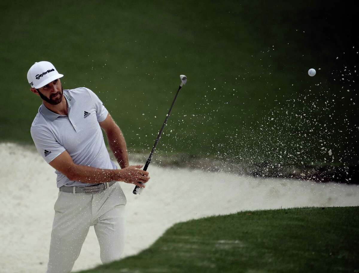 Dustin Johnson hits from a bunker on the 10th hole during a practice round for the Masters golf tournament Wednesday in Augusta, Ga.