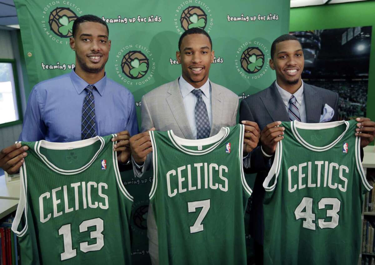 Boston Celtics 2012 draft picks, from left, center Fab Melo and forwards Jared Sullinger and Kris Joseph hold up their jerseys during an introductory NBA basketball news conference in Boston on July 2, 2012.