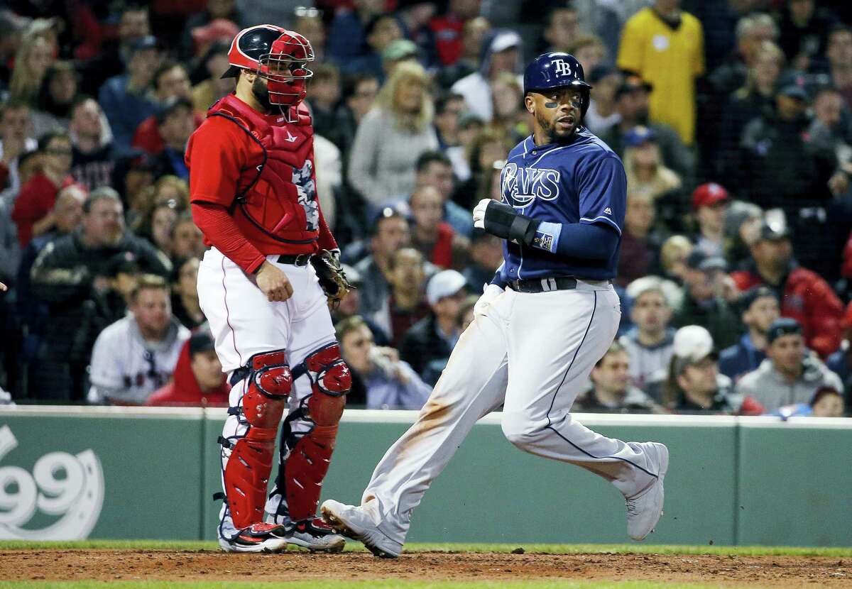 The Rays’ Rickie Weeks, right, looks back as he crosses home plate in front of Sandy Leon on a two-run single by Tim Beckham in the fourth inning Friday.