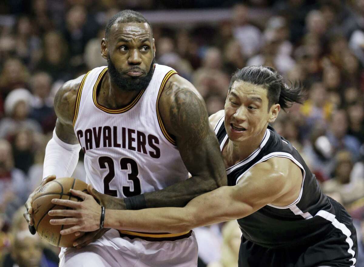 Cleveland Cavaliers’ LeBron James (23) drives against Brooklyn Nets’ Jeremy Lin (7) in the second half of an NBA basketball game, Friday in Cleveland.