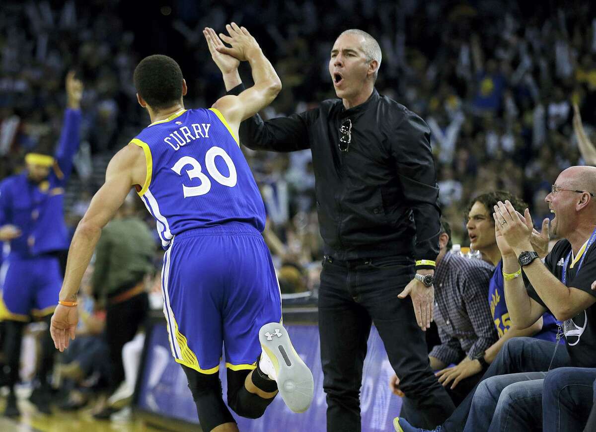 Golden State Warriors’ Stephen Curry celebrates with a fan after scoring against the Washington Wizards during the second half of an NBA basketball game on April 2, 2017 in Oakland, Calif.