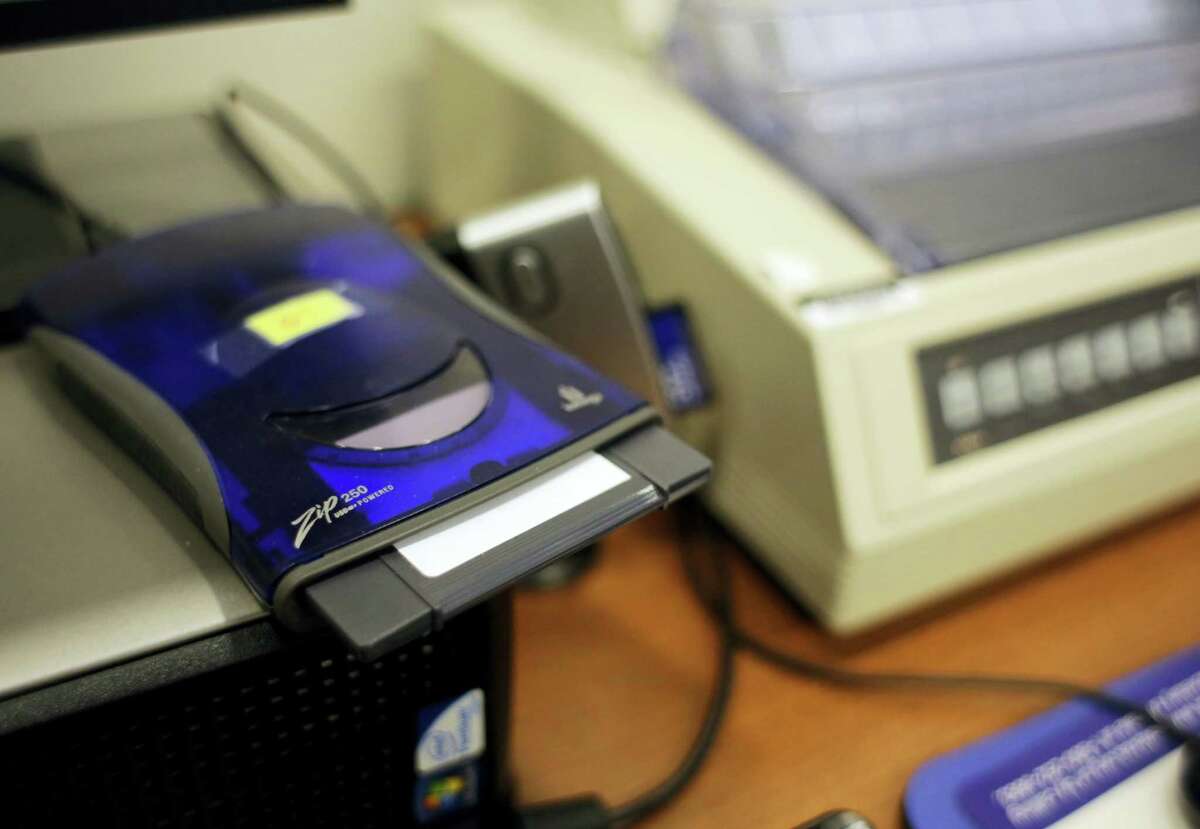 In this March 9, 2017 photo, a zip disk drive and dot matrix printer sit at the Bexar County Elections office in San Antonio. Bexar County’s voting equipment is among the oldest in America’s second-largest state and will have to be replaced soon. But money to do so is scarce, and that scenario is playing out around the country.
