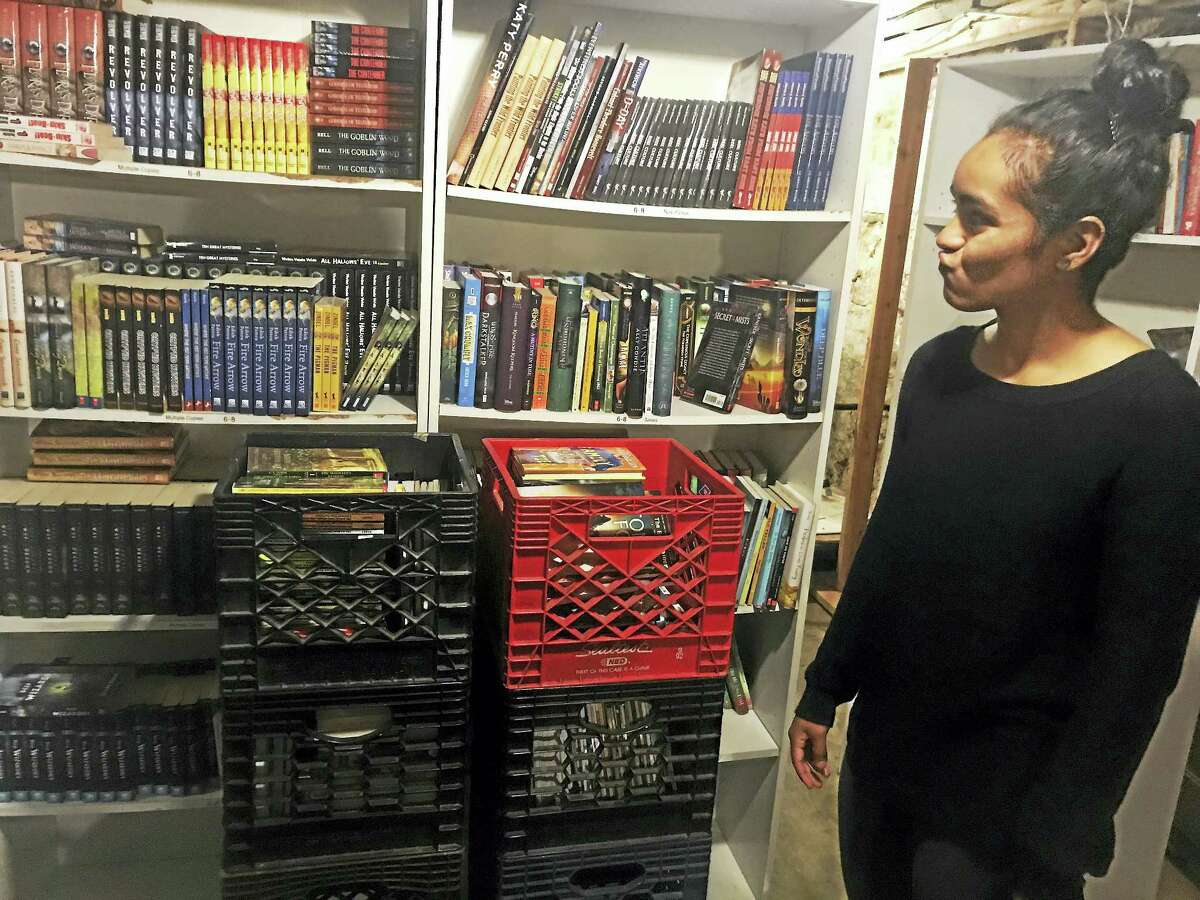 New Haven Reads Book Bank and Operations Director Victoria Sanchez stands next to books that were saved following a leak in the basement of the organization’s book bank at 45 Bristol St. Thursday in New Haven.
