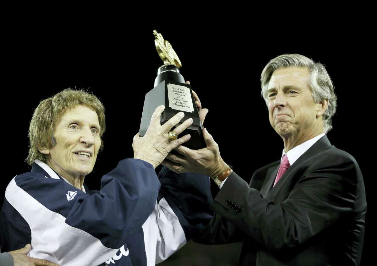 Tigers owner Mike Ilitch, left, and then general manager Dave Dombrowski, lift the William Harridge Trophy after their team won the ALCS in 2012.