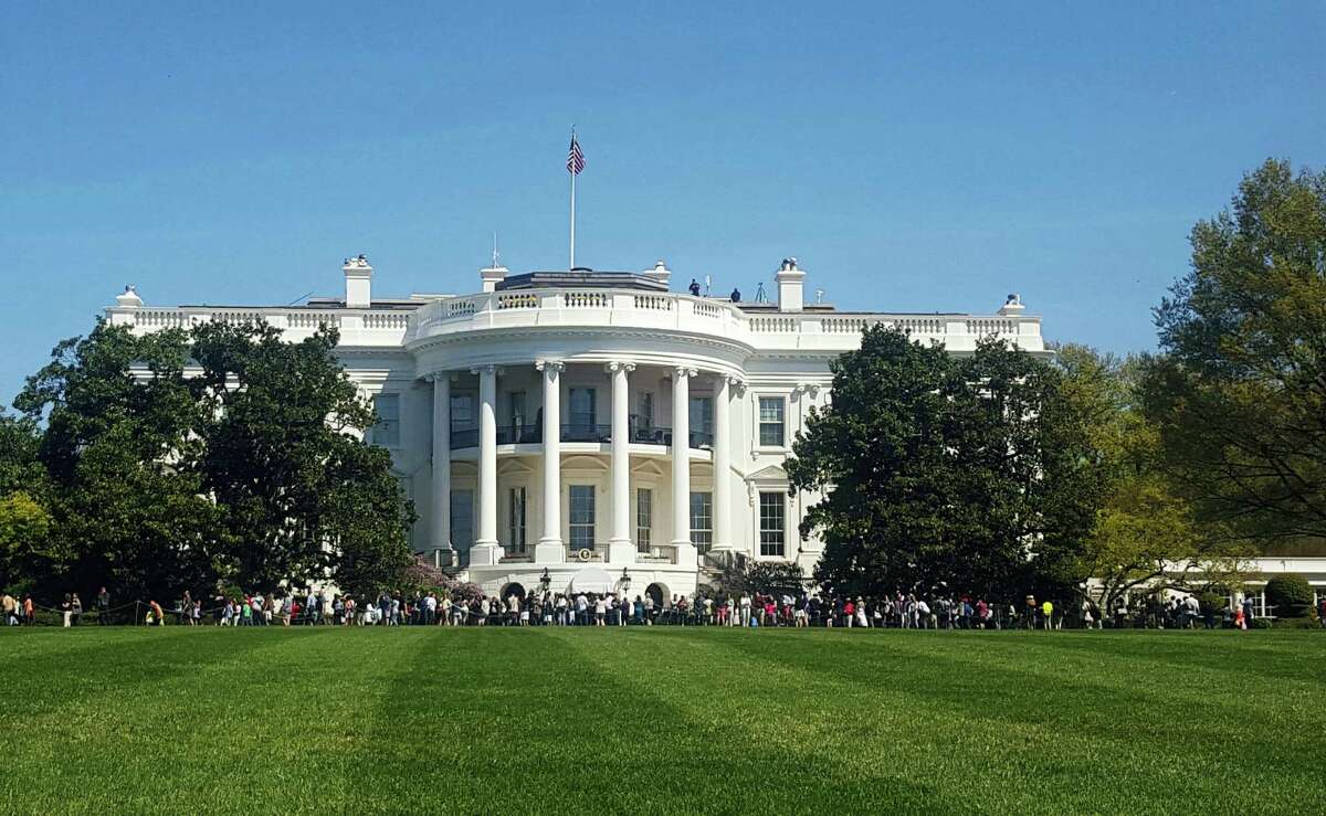In this April 17, 2016, file photo, people visit the south lawn during the annual White House Spring Garden tours in Washington. The U.S. Secret Service says a person is under arrest after climbing a fence and getting onto the south grounds of the White House. The breach happened at about 11:38 p.m. Friday, March 10, 2017. President Donald Trump was at the White House.