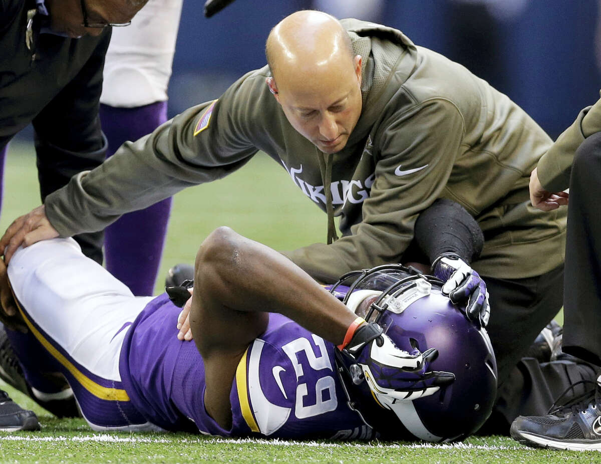 Minnesota Vikings cornerback Xavier Rhodes (29) is attended to by head trainer Eric Sugarman during a game om 2013.