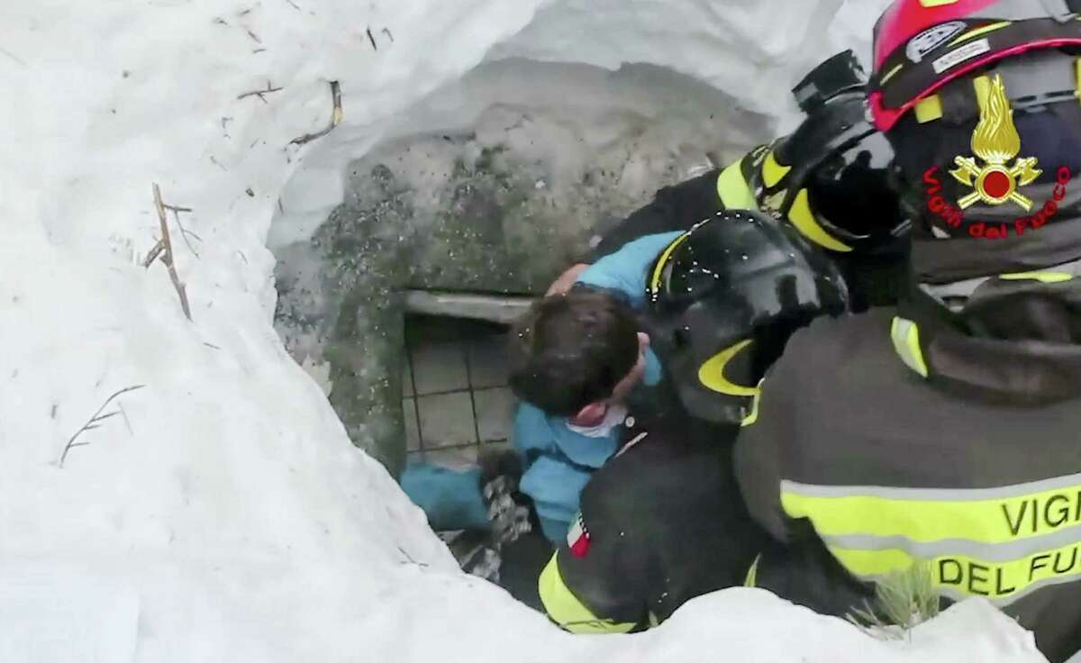 This frame from video shows Italian firefighters extracting a boy alive from under snow and debris of an hotel that was hit by an avalanche on Wednesday, in Rigopiano, central Italy, Friday, Jan. 20, 2017.