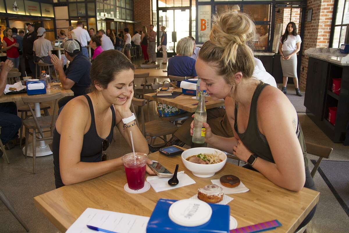 Sarah Thornton (left) and Katie Higgins have lunch at The Bottling Department, the new food hall at The Pearl, on Thursday.