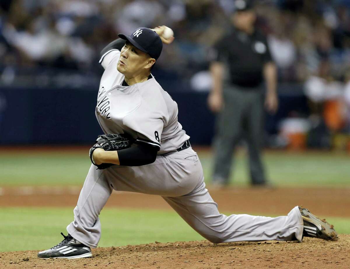 FILE - In this Sept. 21, 2016, file photo, New York Yankees’ Masahiro Tanaka, of Japan, pitches to the Tampa Bay Rays during the sixth inning of a baseball game in St. Petersburg, Fla. Tanaka says he is not thinking about his ability to opt out of his contract following this season, give up $69 million in salary from 2018-20 and become a free agent. (AP Photo/Chris O’Meara, File)