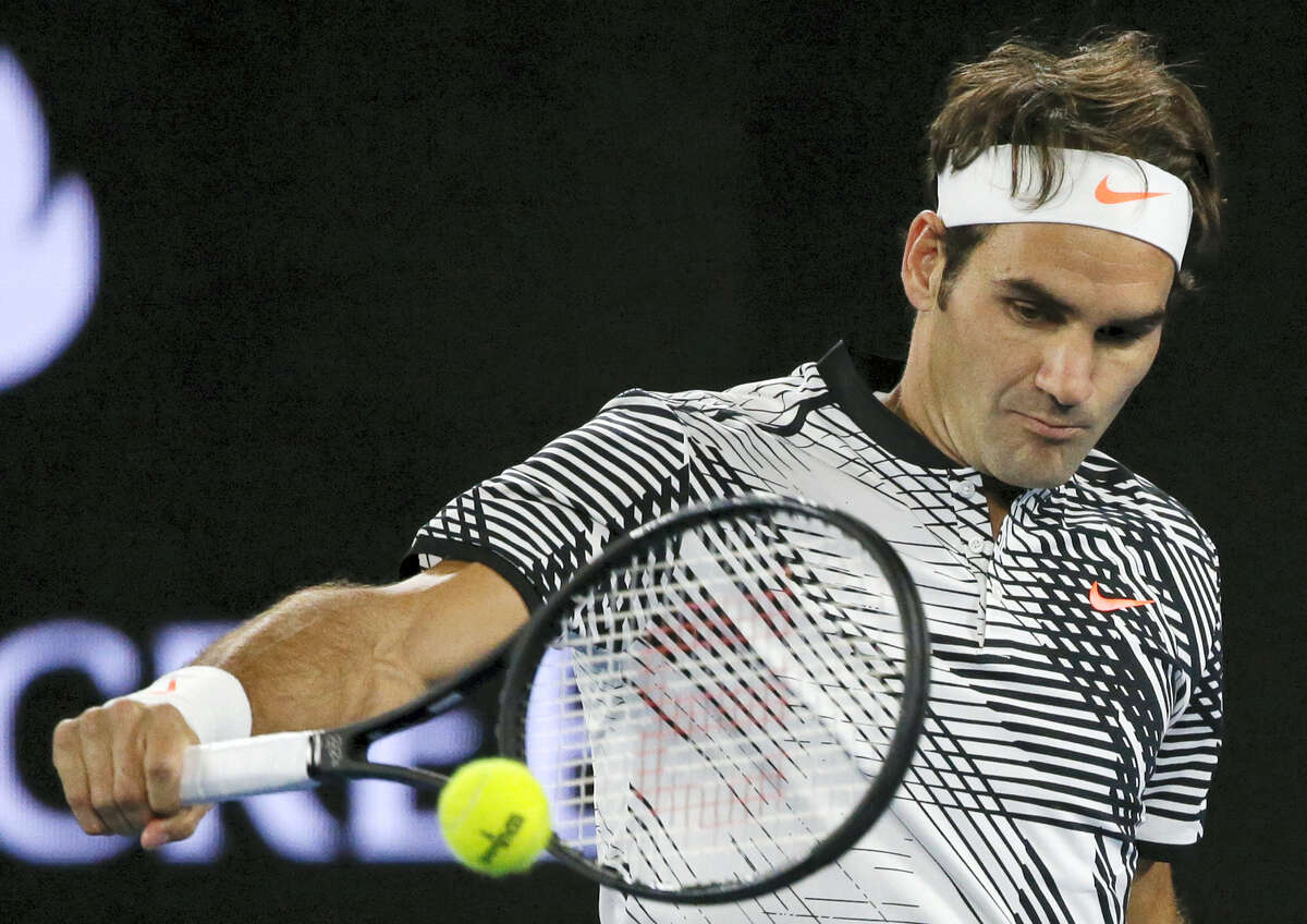 Roger Federer makes a backhand return to Tomas Berdych during their third-round match at the Australian Open on Friday.