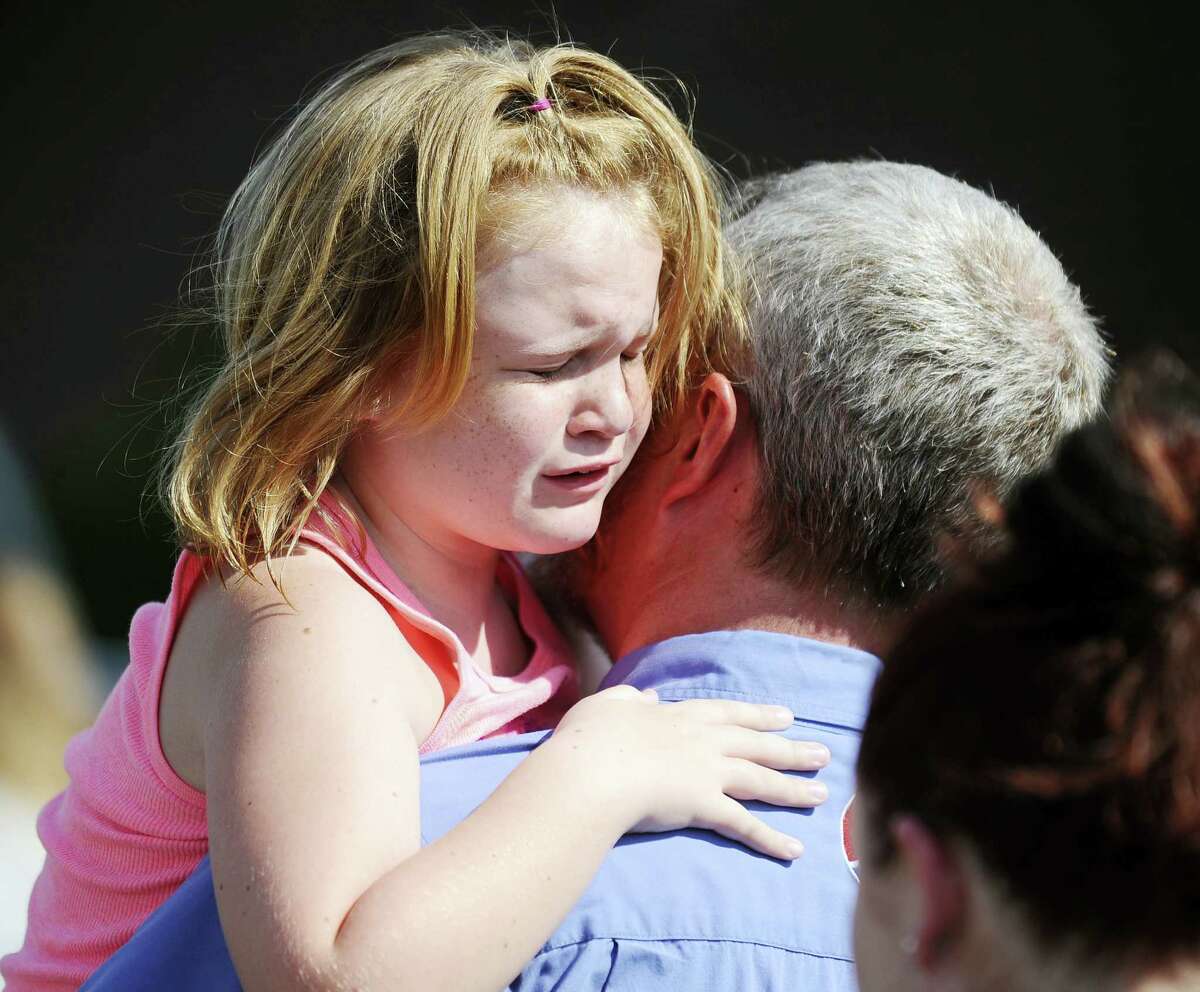 Rainier Ehrhardt — the associated press Lilly Chapman, 8, cries after being reunited with her father, John Chapman, at Oakdale Baptist Church on Wednesday in Townville, S.C. Students were evacuated to the church following a shooting at Townville Elementary School.