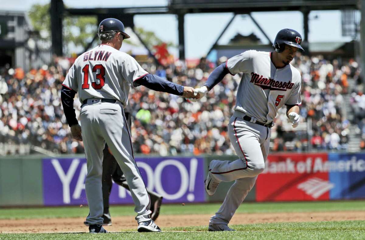 Minnesota Twins’ Eduardo Escobar, right, shakes hands with third base coach Gene Glynn (13) after hitting a solo home run against the San Francisco Giants during the second inning of a baseball game on June 11, 2017 in San Francisco.