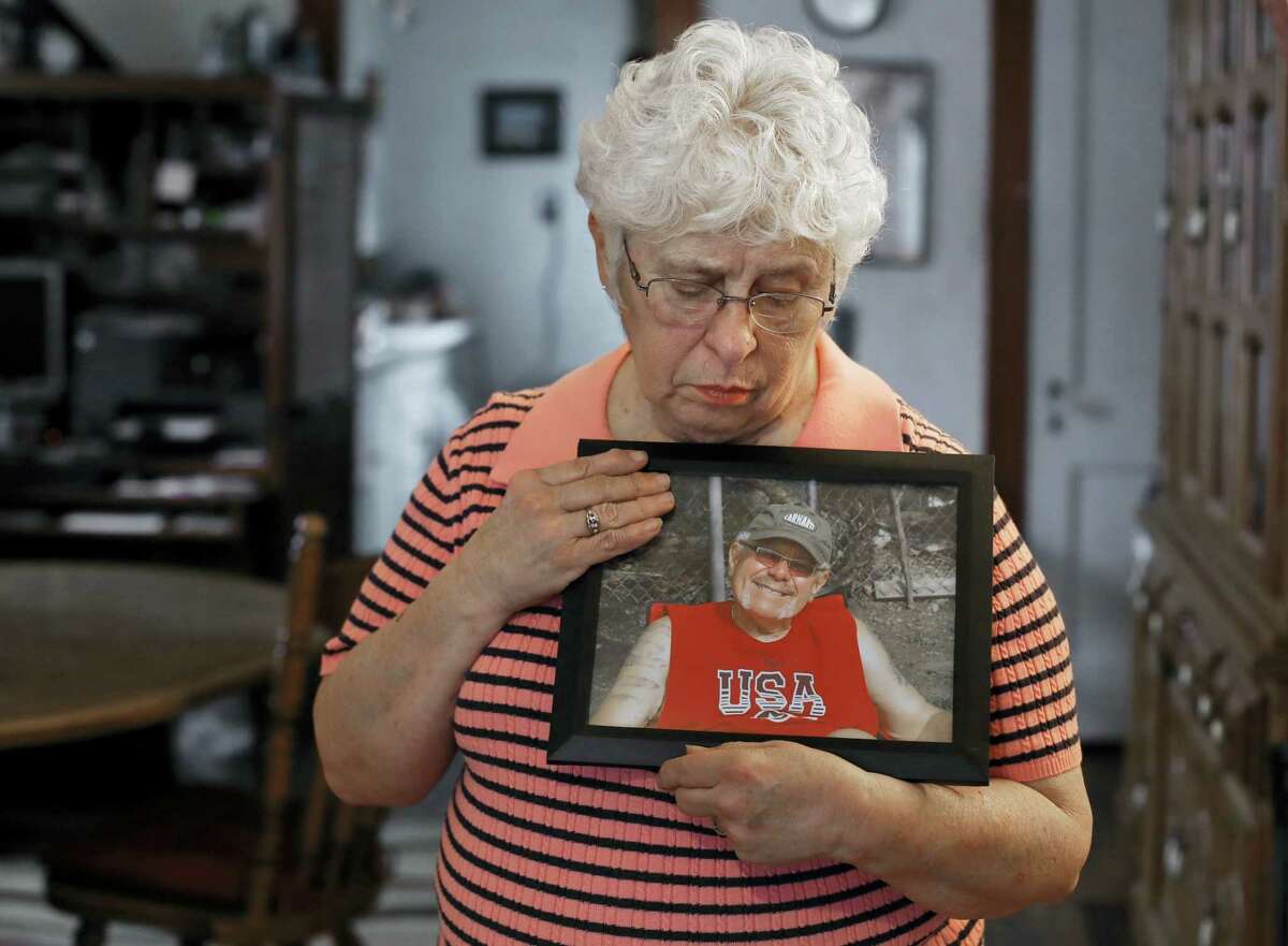 In this Thursday, Jan. 26, 2017, photo, Kay Taynor holds a photo of her late husband, Gary, in Toledo, Ohio. Dozens of patients from a now-closed memory loss clinic in Ohio say its director told them they had Alzheimer’s disease when they really didn’t. More than 50 people have sued, saying they thought for months they had the mind-robbing disease. Taynor was diagnosed with Alzheimer’s on her second visit to clinic director Sherry-Ann Jenkins and then referred five or six friends and family members to her office, including her husband of 48 years. All were told they had the disease, she said, but her husband, Gary, took it hardest.