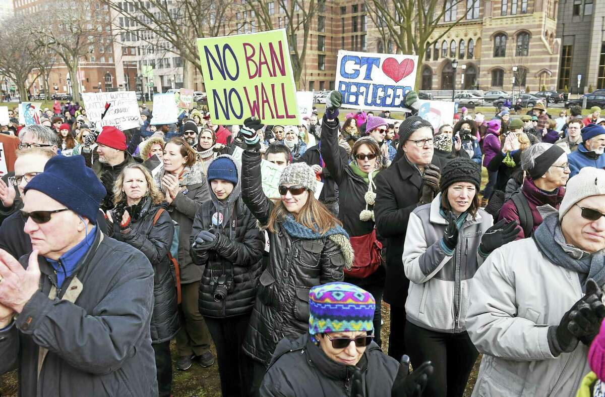 IRIS and their supporters listen to speakers on the New Haven Green at a rally following the March for Refugees Sunday in response to President Trump’s executive order concerning a temporary immigration ban from seven Muslim-majority countries.