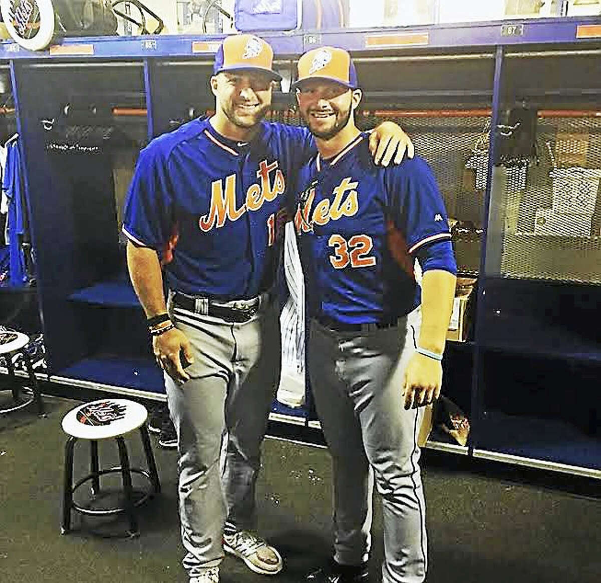 Milford’s Joe Zanghi, right, poses with former NFL quarterback and Zanghi’s current minor-league baseball teammate Tim Tebow inside the Columbia Fireflies’ clubhouse.