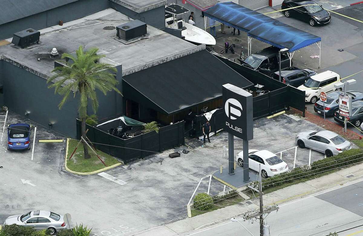 In this file photo, law enforcement officials work at the Pulse gay nightclub in Orlando, Fla., following the a mass shooting. Audio recordings of 911 calls released Tuesday, Aug. 30, by the Orange County Sheriff’s Office show mounting frustration by friends and family members who were texting, calling and video-chatting with trapped patrons of the Pulse nightclub where Omar Mateen opened fire in June. A U.S. law enforcement official says the FBI has arrested the wife of the Orlando nightclub shooter. The official says Noor Salman was taken into custody Monday in the San Francisco area and is due in court Tuesday in California. She’s facing charges in Florida including obstruction of justice.