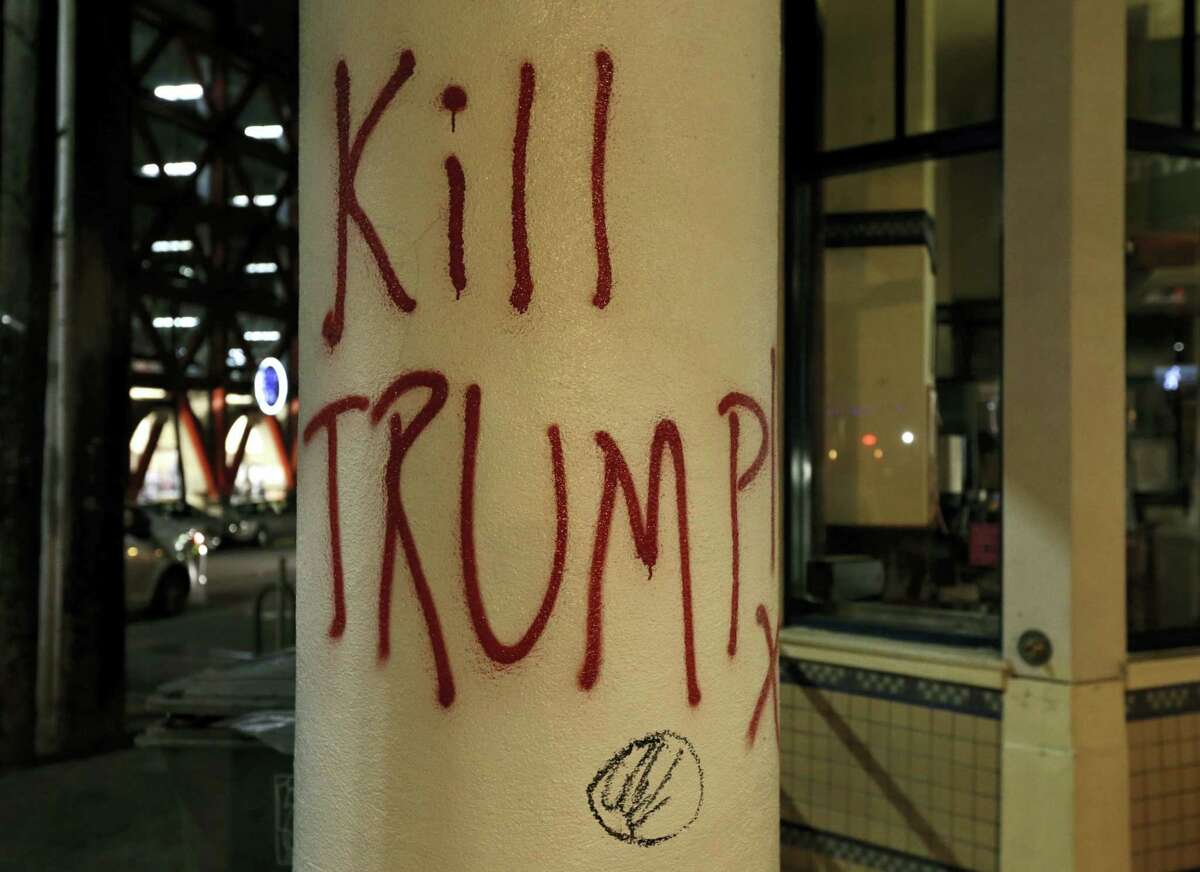Graffiti left by protesters who were against a scheduled speaking appearance by Breitbart News editor Milo Yiannopoulos is seen Wednesday, Feb. 1, 2017, in Berkeley, Calif. A small group of people with their faces covered broke windows, hurled fireworks at police officers and threw smoke bombs, prompting UC Berkeley officials to cancel Yiannopoulos’s talk Wednesday evening.