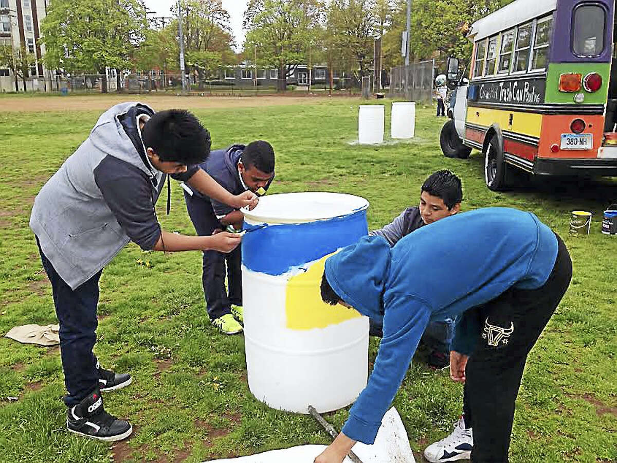 Sixth-grade students at Fair Haven School paint a trash can as part of a beautification effort at Criscuolo Park. From left, Waldiny Perez Perez, Yeuris Asensio, Mark Anthony Ramirez and Milton Pinchu.