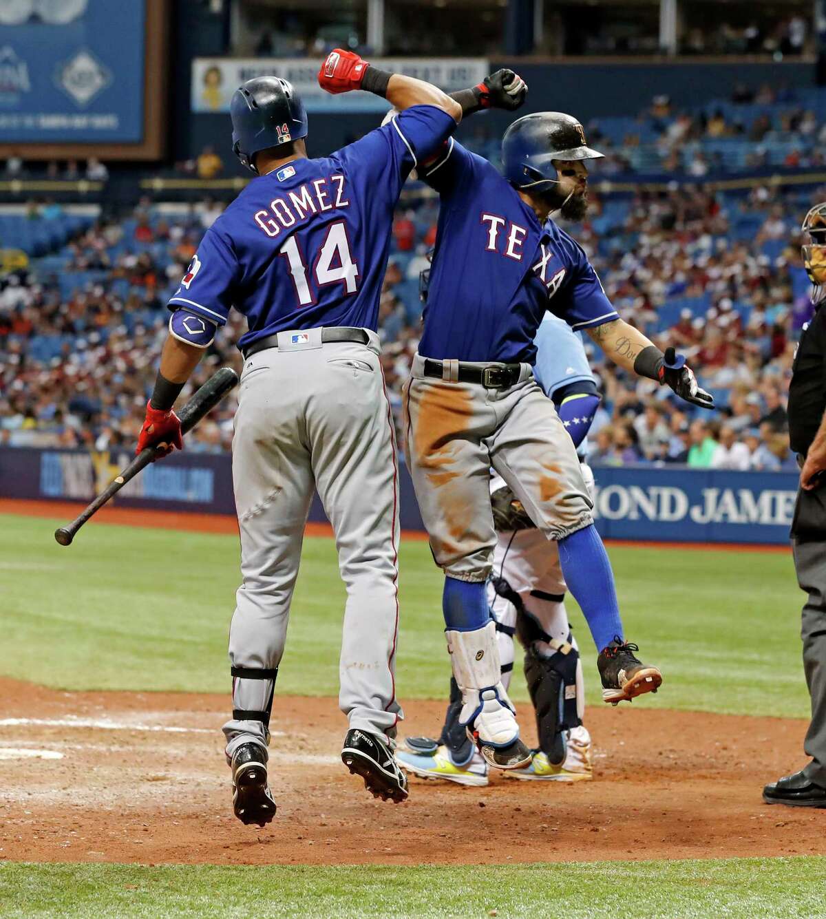 Texas Rangers' Rougned Odor, right, celebrates his two-run home run with Carlos Gomez during the eighth inning of a baseball game against the Tampa Bay Rays, Sunday, July 23, 2017, in St. Petersburg, Fla. (AP Photo/Mike Carlson)