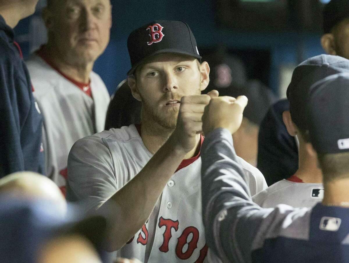 Boston Red Sox starting pitcher Chris Sale is congratulated in dugout during the eighth inning of a baseball game against the Toronto Blue Jays in Toronto on April 20, 2017.