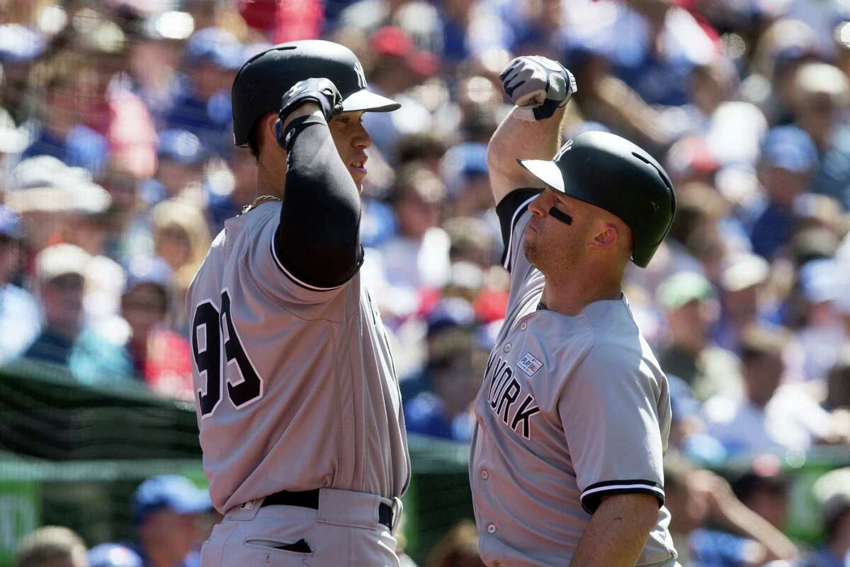 New York Yankees' Brett Gardner, right, celebrates with teammate Aaron Judge after hitting a solo home run off Toronto Blue Jays relief pitcher Jason Grilli during the eighth inning of a baseball game in Toronto, Saturday, June 3, 2017. (Chris Young/The Canadian Press via AP)