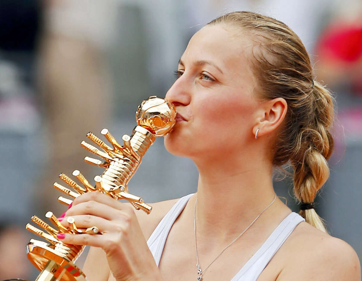Petra Kvitova of the Czech Republic kisses the trophy after defeating Svetlana Kuznetsova of Russia in their women’s singles final match at the Madrid Open Tennis tournament in Madrid, Spain on May 9, 2015.