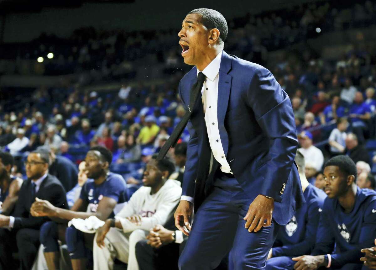 UConn men’s basketball coach, Kevin Ollie yells to his players from the sidelines in the first half against Tulsa. The Huskies play at Memphis Thursday.