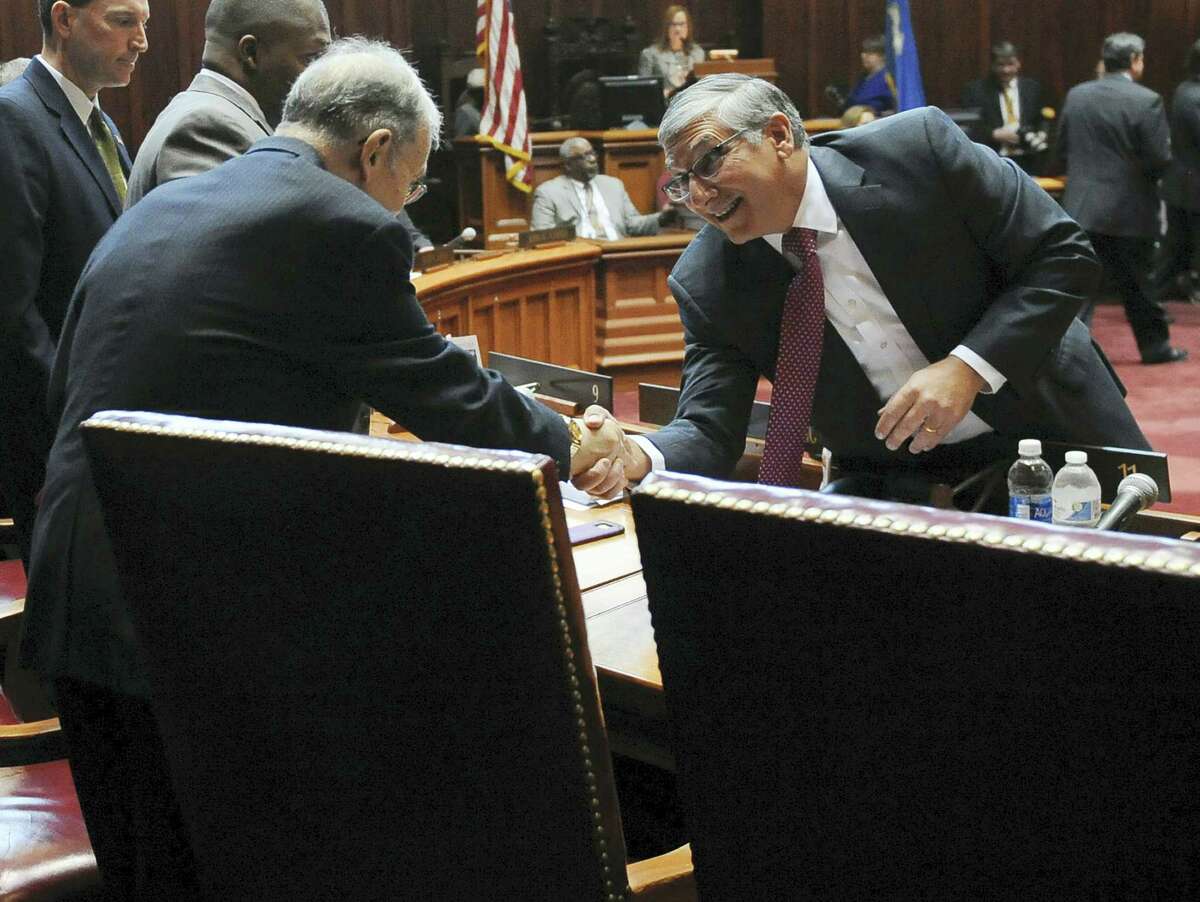 Senate Republican President Pro Tempore Len Fasano, R-North Haven, greets Senate President Pro Tempore Martin M. Looney, D-New Haven, right, during the opening session at the state Capitol, Wednesday, Jan. 4, 2017, in Hartford.