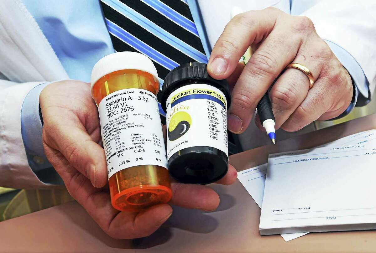 Pharmacist Nicholas Tamborrino shows a sample of a medical marijuana prescription.