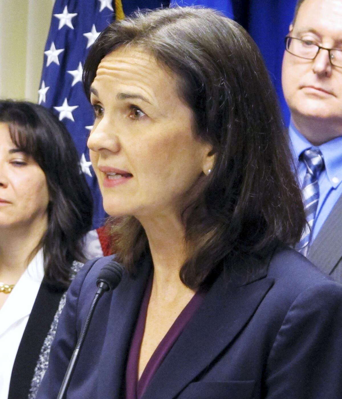 In this file photo, Deirdre Daly, U.S. attorney for Connecticut, stands with other federal officials while announcing a new public corruption task force in New Haven, Conn. Daly is facing an uncertain job future as the presidency changes hands from one political party to another when Donald Trump is sworn into office in January 2017. She has been the top federal prosecutor in the state since 2014, after being nominated by outgoing Democratic President Barack Obama.
