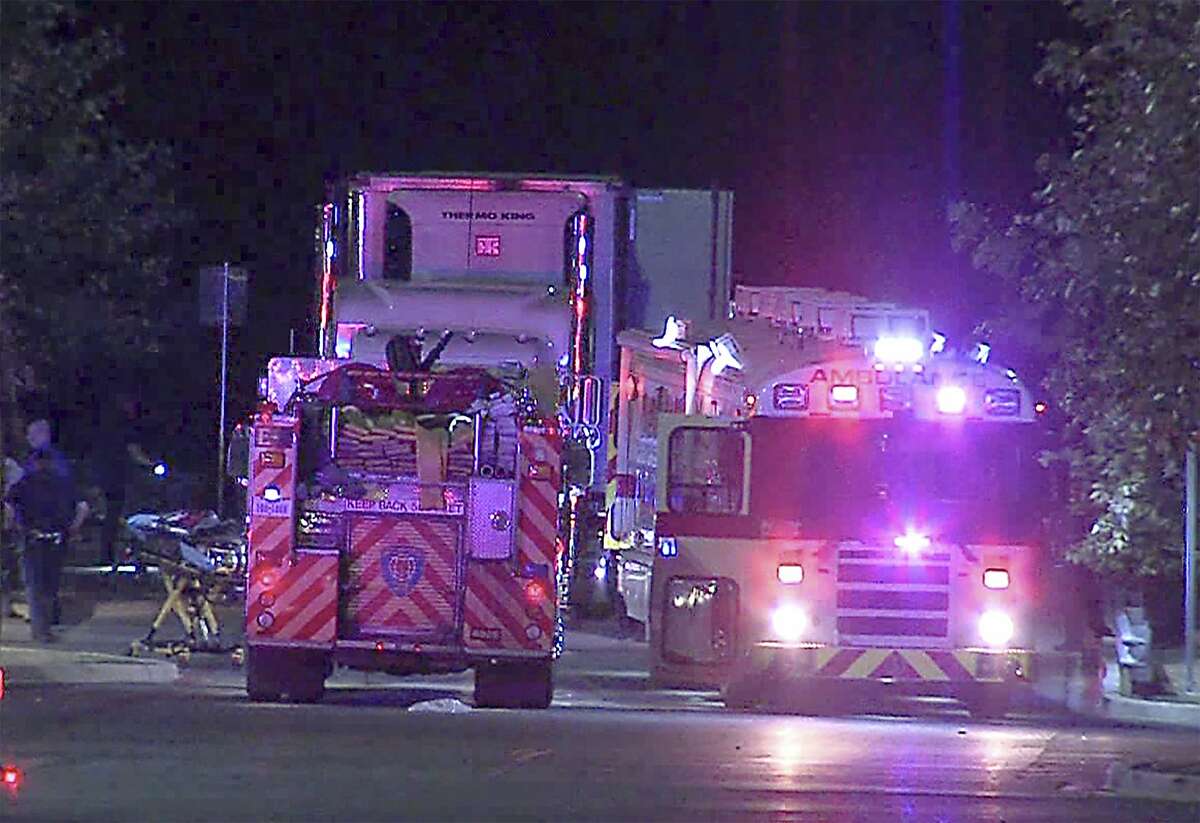 The San Antonio Fire Department Mass Casualty Evacuation Ambulance and other EMS units park next to and eighteen wheeler at a Walmart parking lot at IH-35 South and Palo Alto Road, Sunday, July 23, 2017. Law enforcement personnel found 38 immigrants inside a tractor-trailer parked at the store. Eight were found dead and two died later. Seventeen were transported with life-threatening injuries.