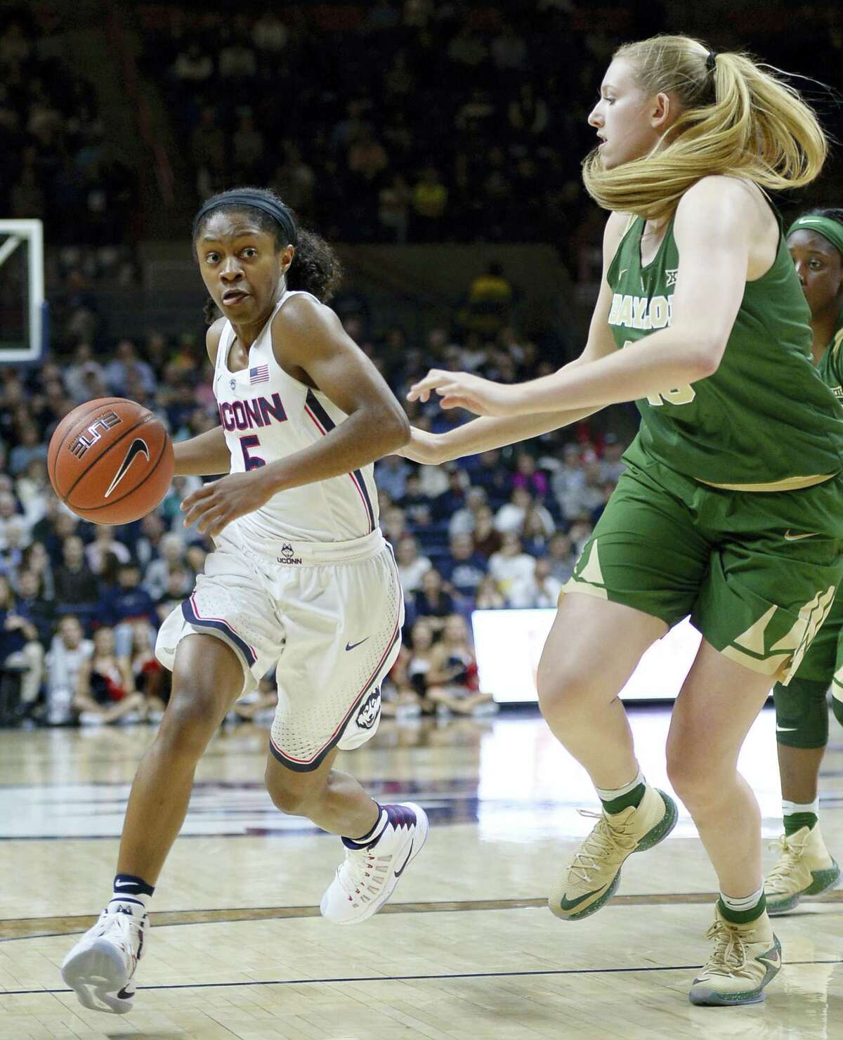 UConn’s Crystal Dangerfield dribbles around Baylor’s Lauren Cox in the first half Thursday.