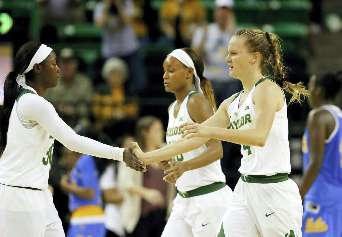Baylor’s Alexis Jones, left, Nina Davis, rear, and Kristy Wallace, front right, of Australia celebrate a score against UCLA during an NCAA college basketball game, Monday Nov. 14, 2016, in Waco, Texas. (AP Photo/Tony Gutierrez)