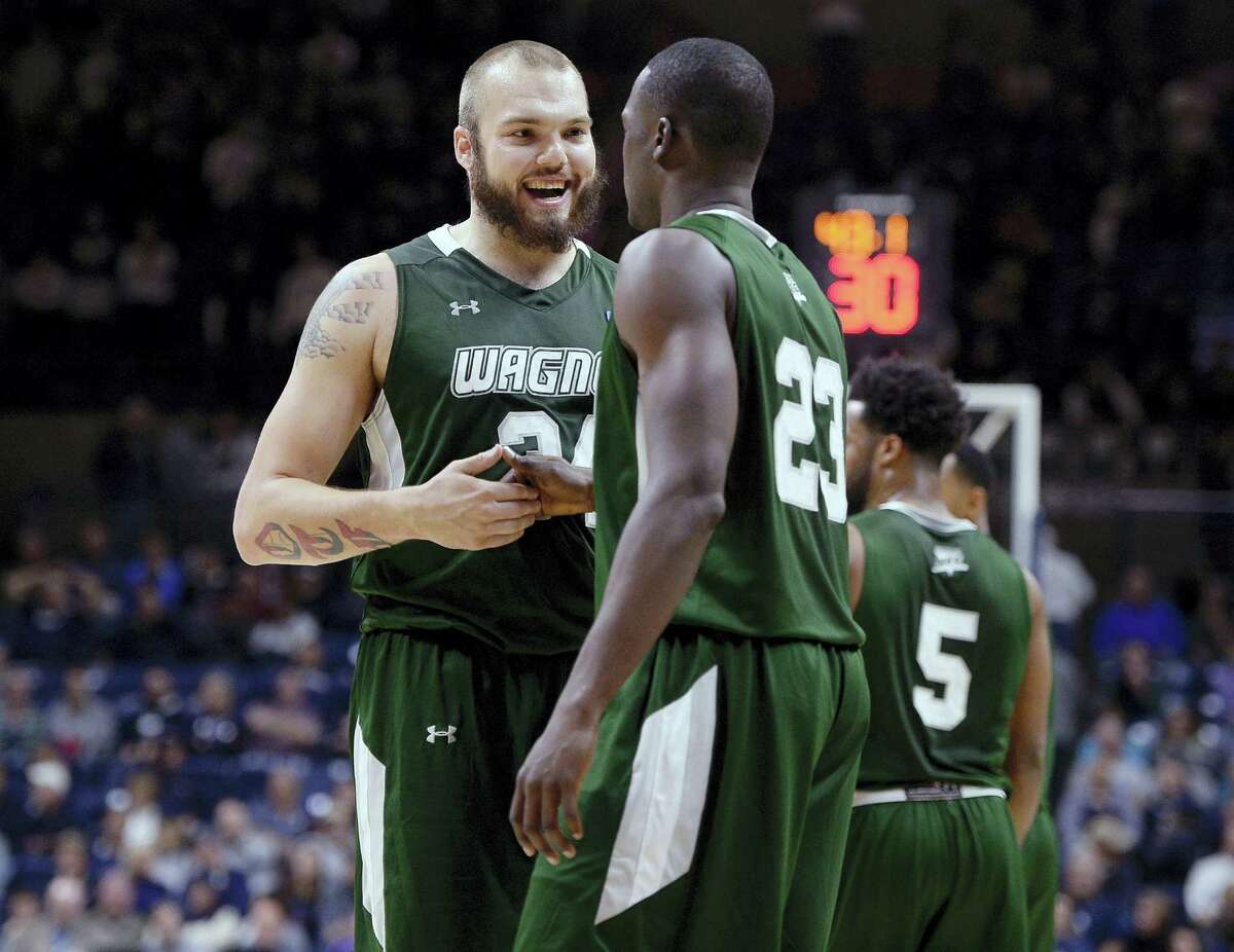 Wagner’s Mike Aaman, left, celebrates with teammate Michael Carey in the final minute of the Seahawks upset win over No. 18 UConn.