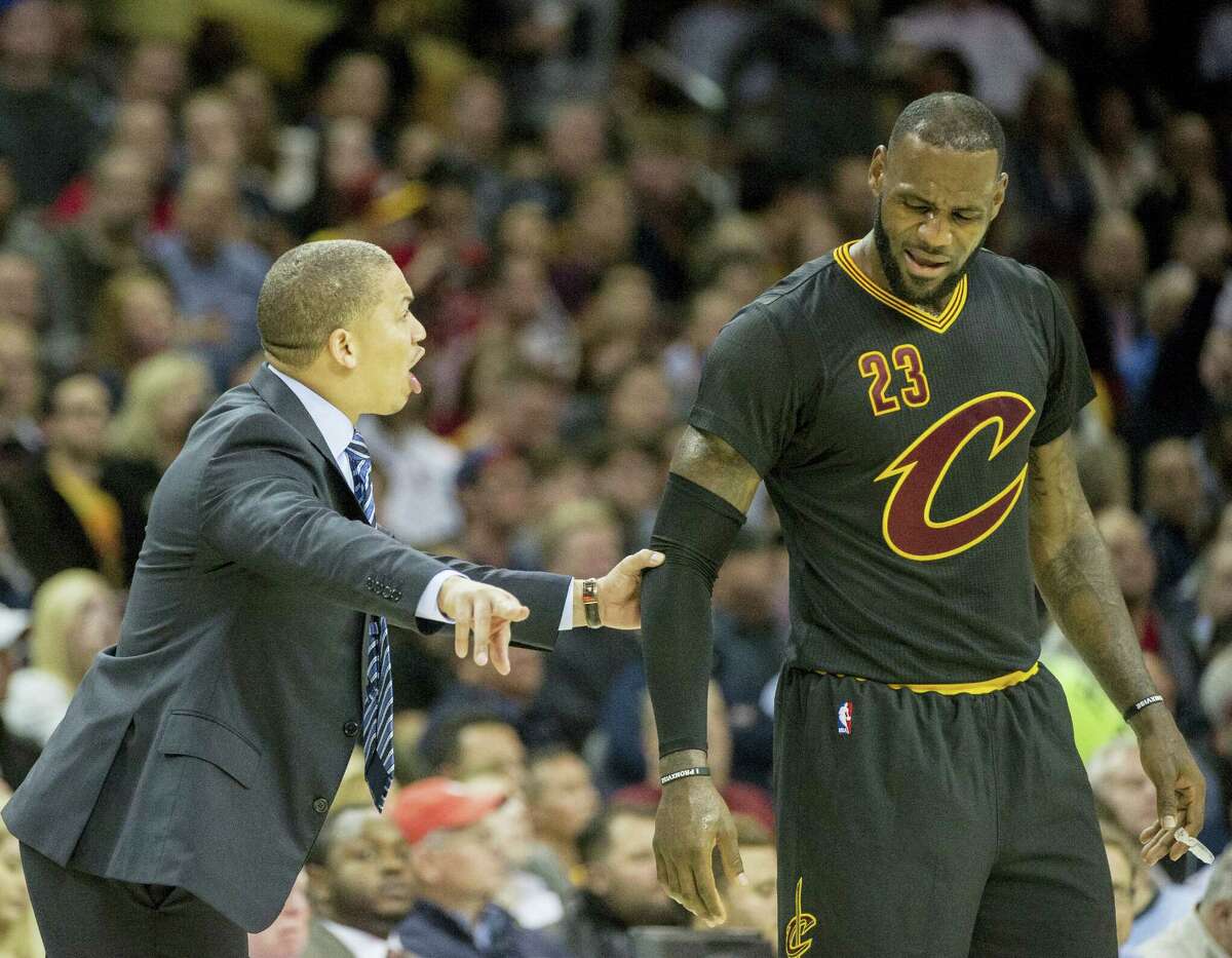 Cleveland Cavaliers head coach Tyronn Lue speaks with LeBron James during the second half of an NBA basketball game against the Atlanta Hawks in Cleveland on Tuesday, Nov. 8, 2016. The Hawks won 110-106.