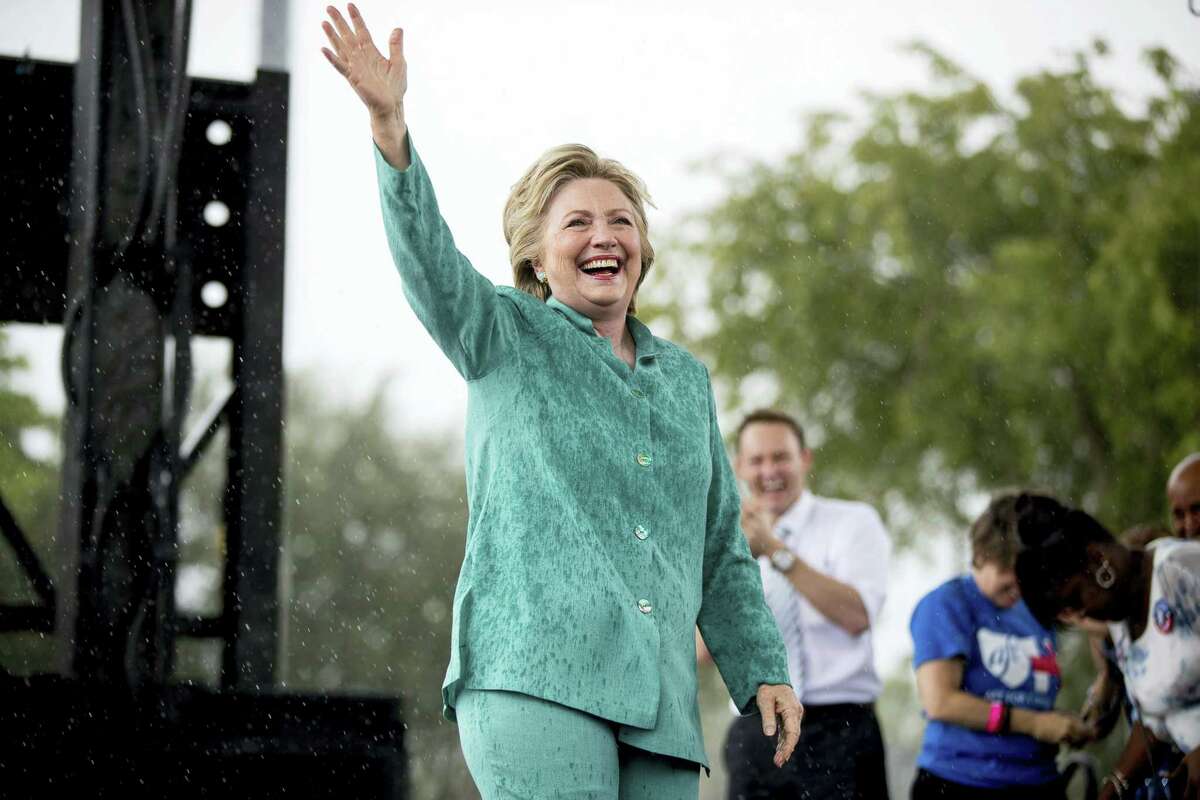 Democratic presidential candidate Hillary Clinton waves after she cut her speech short due to rain at a rally at C.B. Smith Park in Pembroke Pines, Fla. on Nov. 5, 2016.