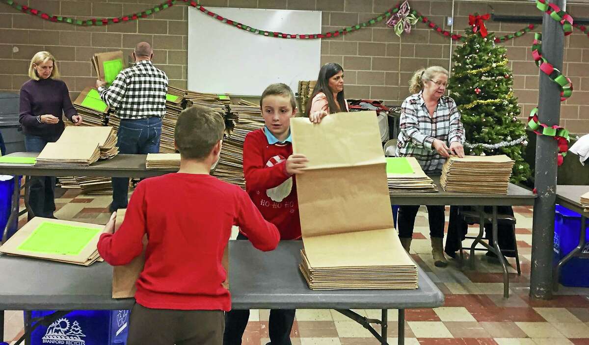 For the past three years, resident Etta Hanlon, in partnership with the town’s Solid Waste Department, has created and distributed 4,000 holiday paper bags — similar to a leaf bag — to Branford schools, churches and town departments to educate residents on how to properly recycle paper items during the holiday season.