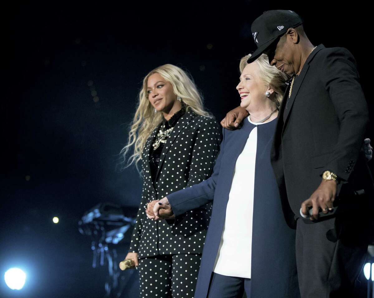 Democratic presidential candidate Hillary Clinton, center, is welcomed to the stage by artists Jay Z, right, and Beyonce, left, during a free concert at at the Wolstein Center in Cleveland, Friday, Nov. 4, 2016.