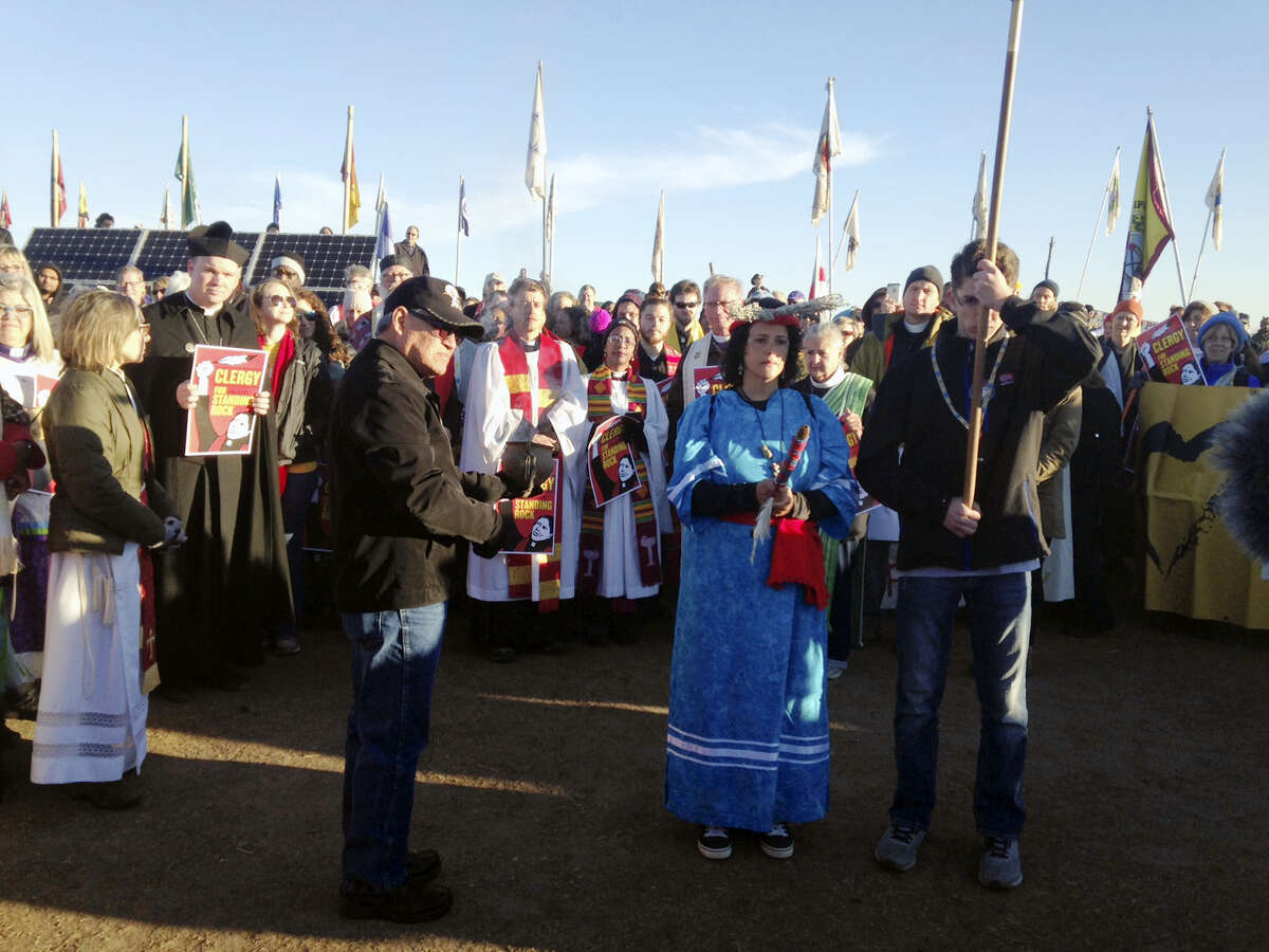 Members of the clergy join protesters against the Dakota Access oil pipeline in southern North Dakota near Cannon Ball on Thursday, Nov. 3, 2016, to draw attention to the concerns of the Standing Rock Sioux and push elected officials to call for a halt to construction. The tribe says the $3.8 billion, four-state pipeline threatens its drinking water and cultural sites. (AP Photo/James MacPherson)