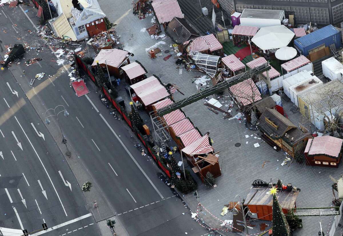 Debris still lies on the crime scene in Berlin, Germany, Wednesday, Dec. 21, 2016, two days after a truck ran into a crowded Christmas market and killed several people.
