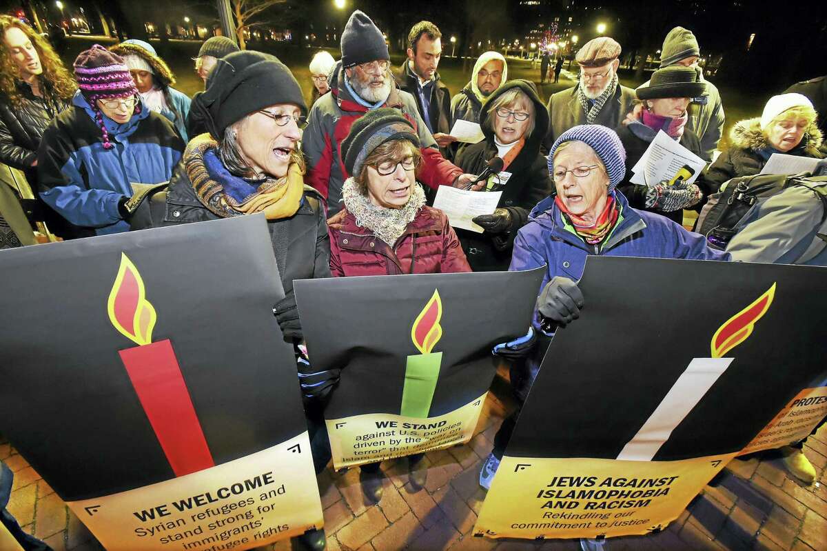 New Haven residents, from left, Ginger Chapman, Ellen Rubin and Susan Bramhall sing “Hannukah, oh Hannukah,” during a demonstration Wednesday in New Haven.