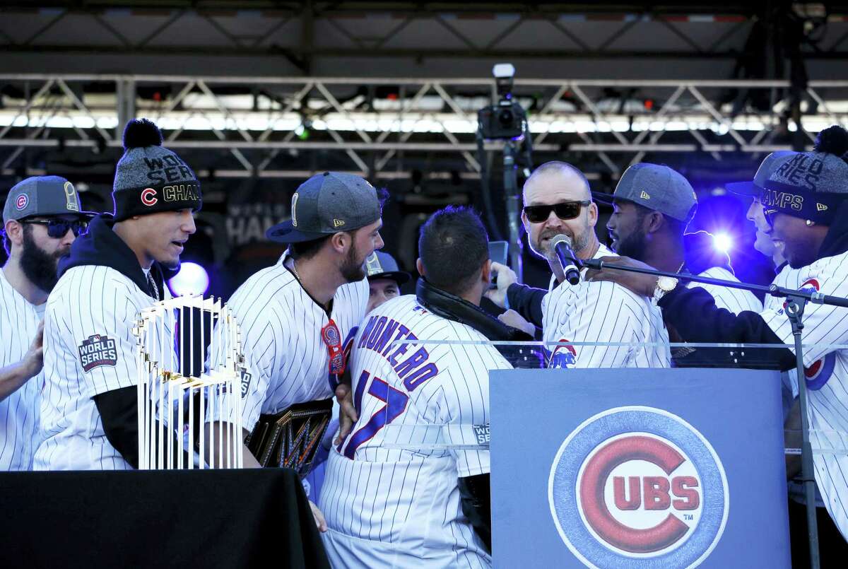 Chicago Cubs’ David Ross takes a photo with teammates during a celebration honoring the World Series champions at Grant Park in Chicago on Friday.