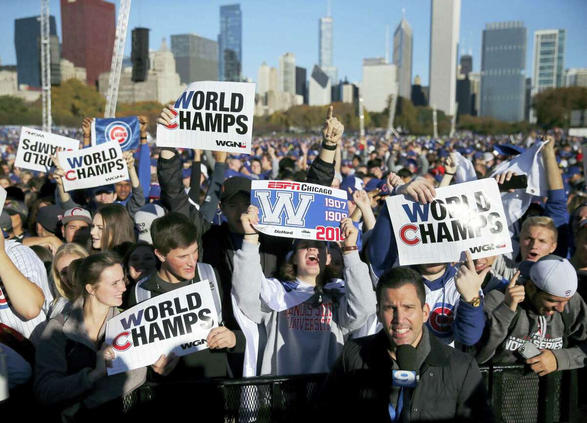 Chicago Cubs fans celebrate before a rally in Grant Park honoring the World Series baseball champions Friday, Nov. 4, 2016, in Chicago.