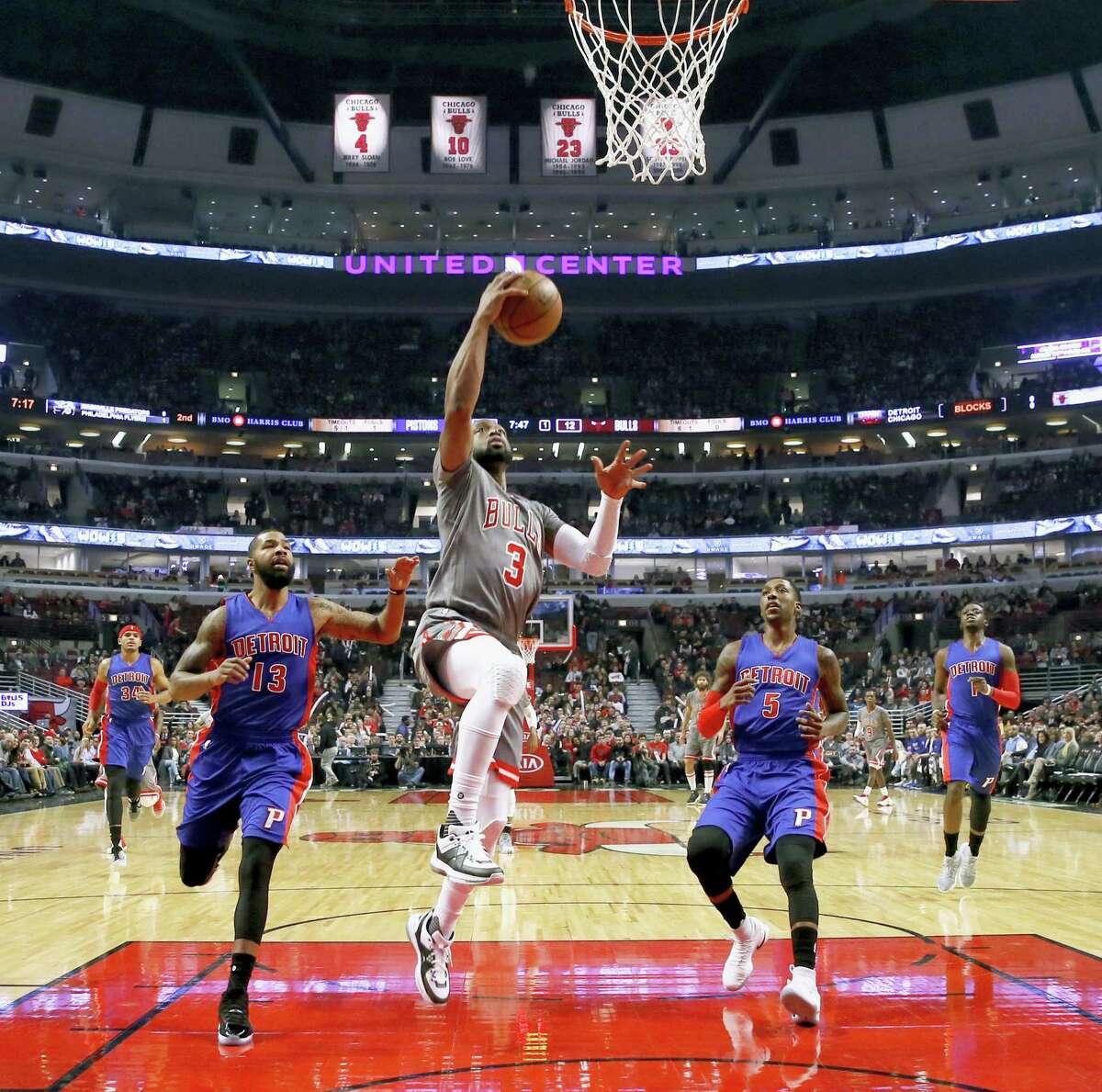 Chicago Bulls’ Dwyane Wade (3) scores past Detroit Pistons’ Marcus Morris (13) and Kentavious Caldwell-Pope during the first half of an NBA basketball game Monday, Dec. 19, 2016 in Chicago.
