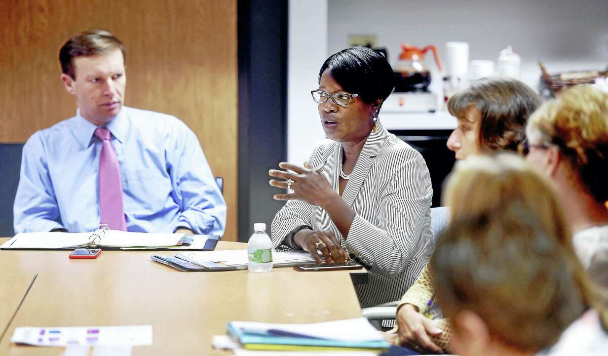 U.S. Sen. Chris Murphy, left, listens to Miriam Delphin-Rittmon, center, commissioner of the Department of Mental Health and Addiction Services, speaks at a roundtable discussion about the opioid epidemic at BHcare in Ansonia Friday.