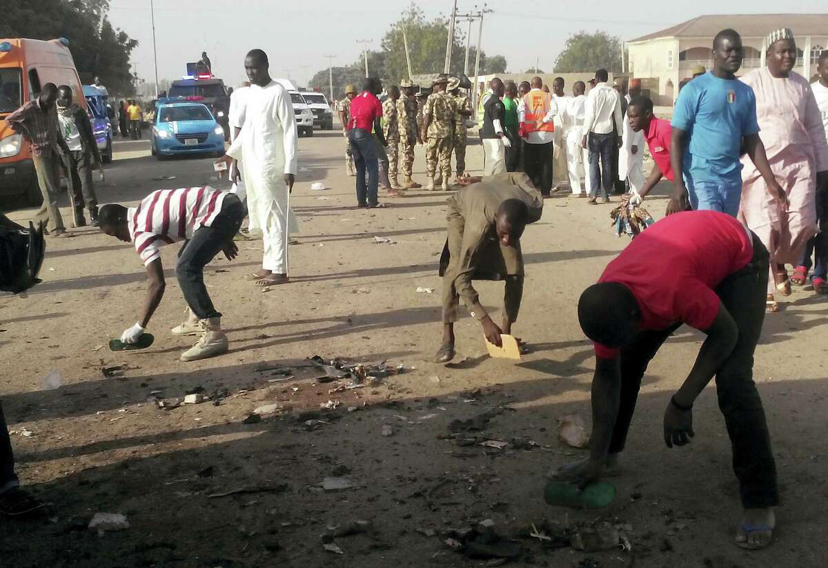 People clear debris after an explosion in Maiduguri, Nigeria, Saturday, Oct. 29, 2016. Twin explosions from female suicide bombers suspected to be with Boko Haram killed nine people and injured more than 20 in Nigeria’s northeastern city of Maiduguri on Saturday morning, officials and witnesses said.