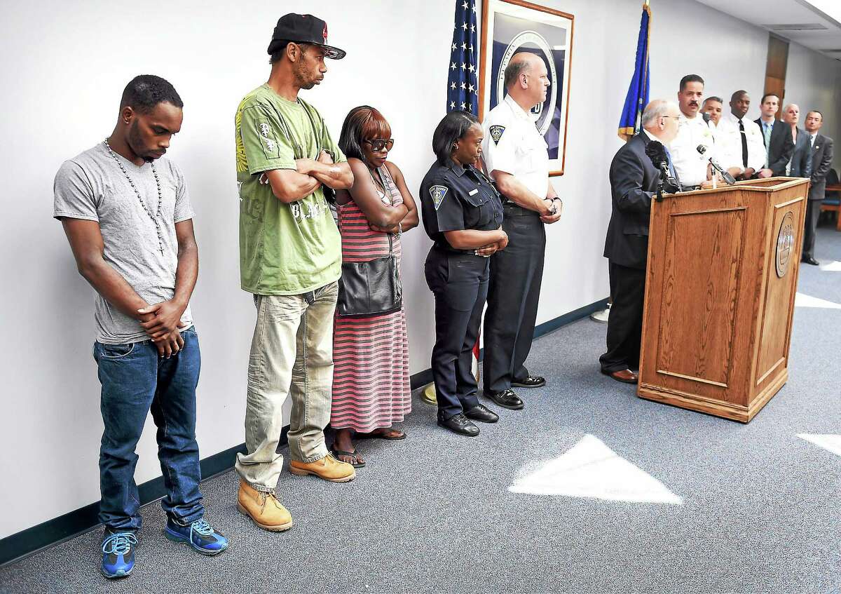 This 2014 photo shows, from left, Tyreese Jones’ brother, William Jowers, and his parents, Jymeson and Felicia Jones, as the New Haven Police Department announced the arrest of Errol Godfrey-Hill in the shooting death of Tyreese Jones.