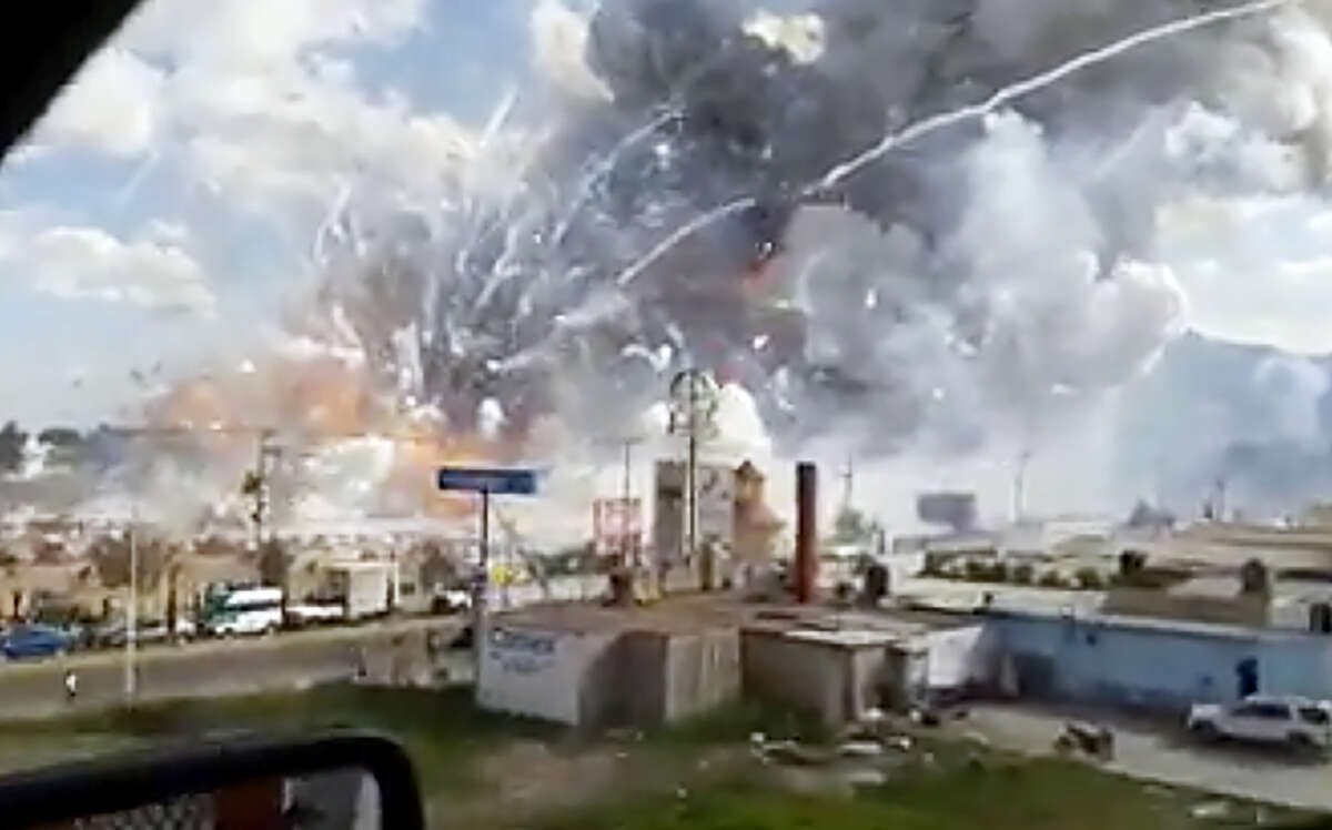 This image made from video shows an explosion ripping through the San Pablito fireworks’ market in Tultepec, Mexico, Tuesday, Dec. 20, 2016. Sirens wailed and a heavy scent of gunpowder lingered in the air after the afternoon blast at the market, where most of the fireworks stalls were completely leveled. According to the Mexico state prosecutor there are at least 26 dead.