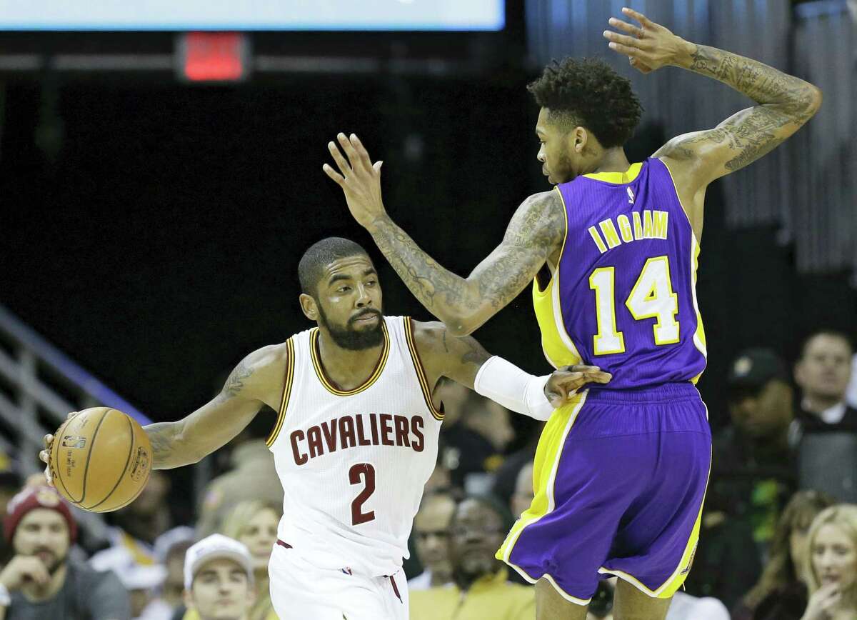 Cleveland Cavaliers’ Kyrie Irving (2) drives past Los Angeles Lakers’ Brandon Ingram (14) in the second half of an NBA basketball game Saturday, Dec. 17, 2016 in Cleveland.