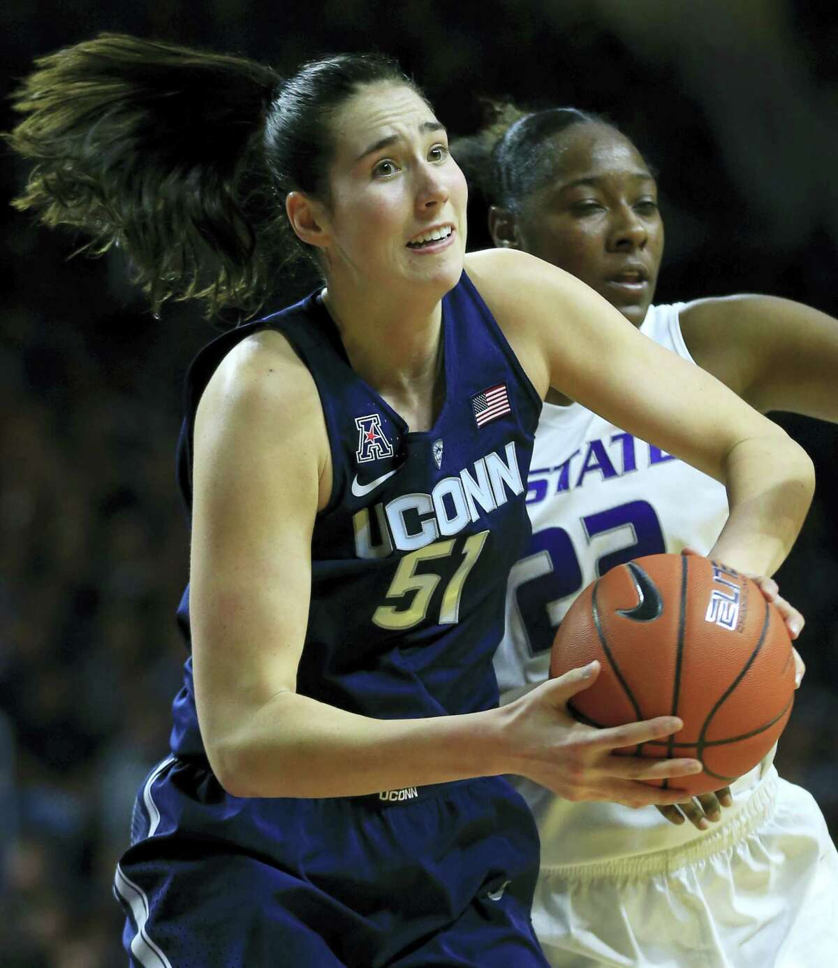 Connecticut center Natalie Butler (51) rebounds in front of Kansas State forward Breanna Lewis (22) during the first half of an NCAA college basketball game in Manhattan, Kan. on Sunday, Dec. 11, 2016.
